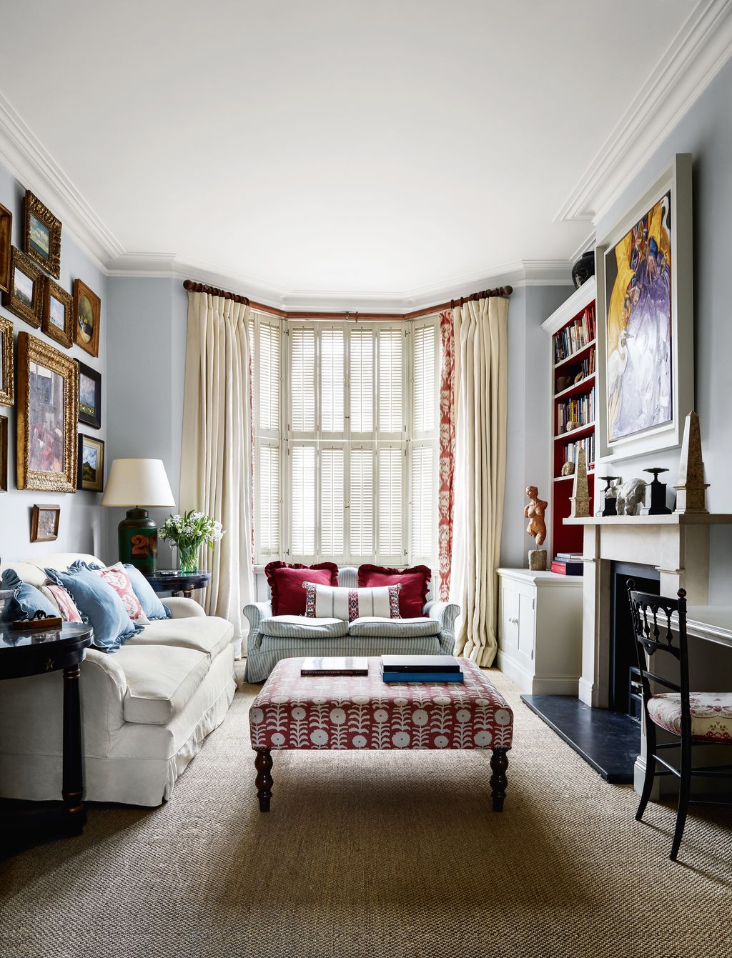 In the drawing room an ottoman in Penny Morrisons ‘Killi linen echoes the warm tones of a Robert Kime trim on the...