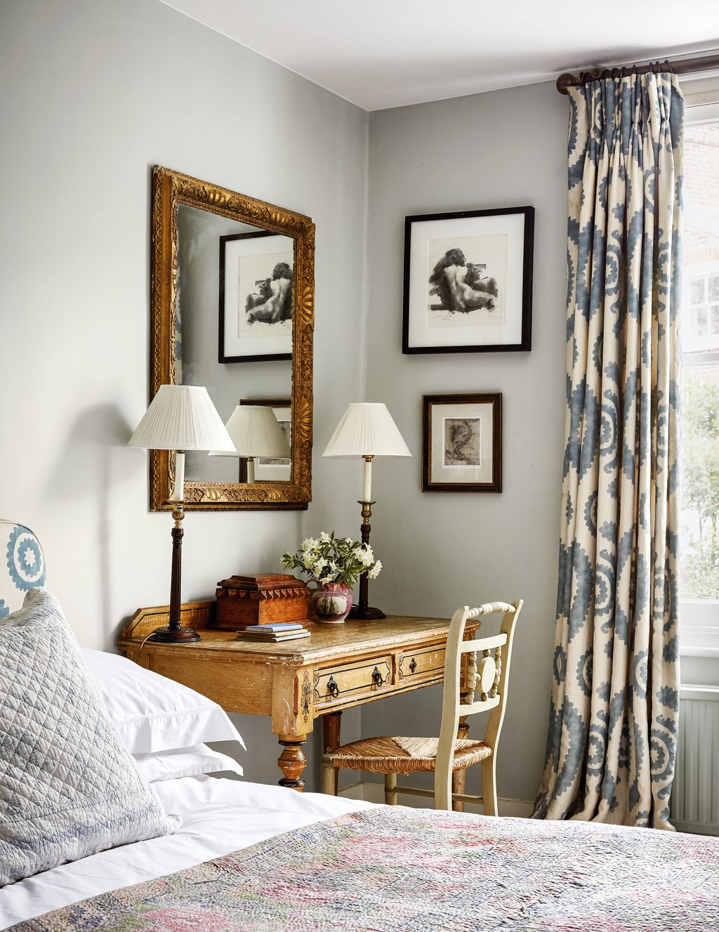 A nude by friend Rosalie Watkins hangs beside curtains in Penny Morrisons ‘Haveli linen in the spare room.