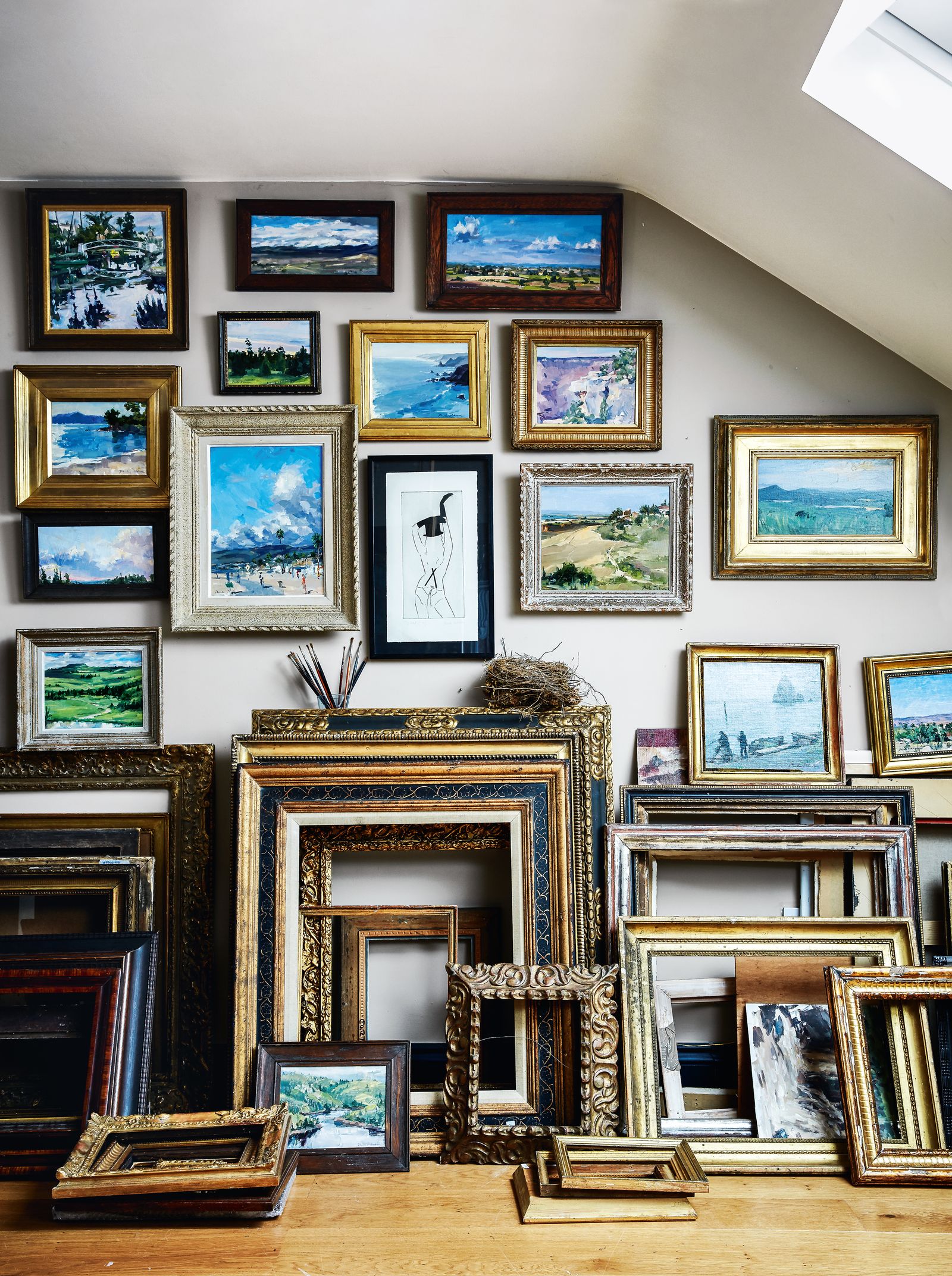 Paintings from Phoebes travels and her collection of frames fill this space at the top of the house.