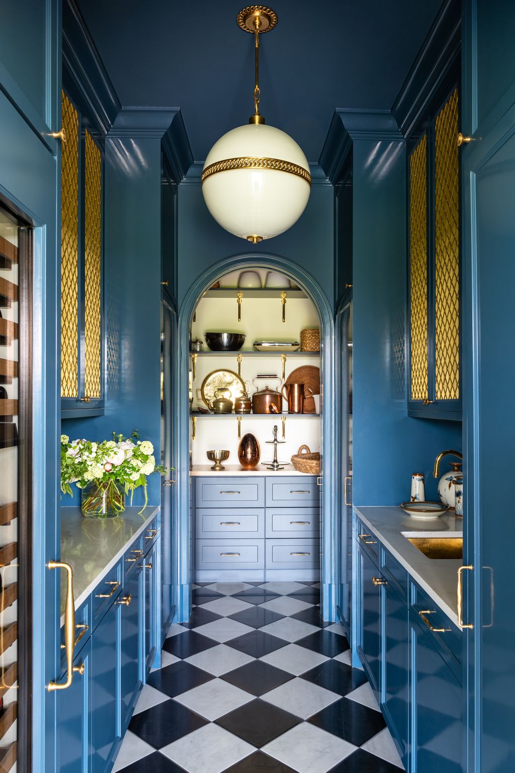 A corner of the house with a bold contrast of blue and brass details