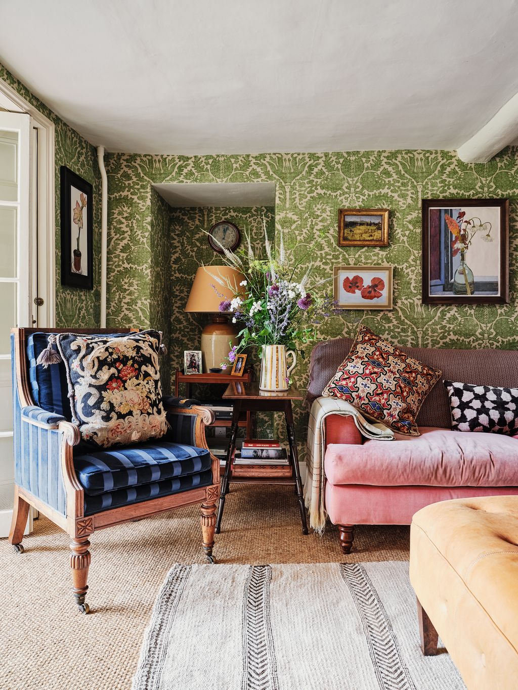 The blue chair was inherited from Hugos father's housenbspHenbury Hall. Above the sofa amongst the botanical paintings...