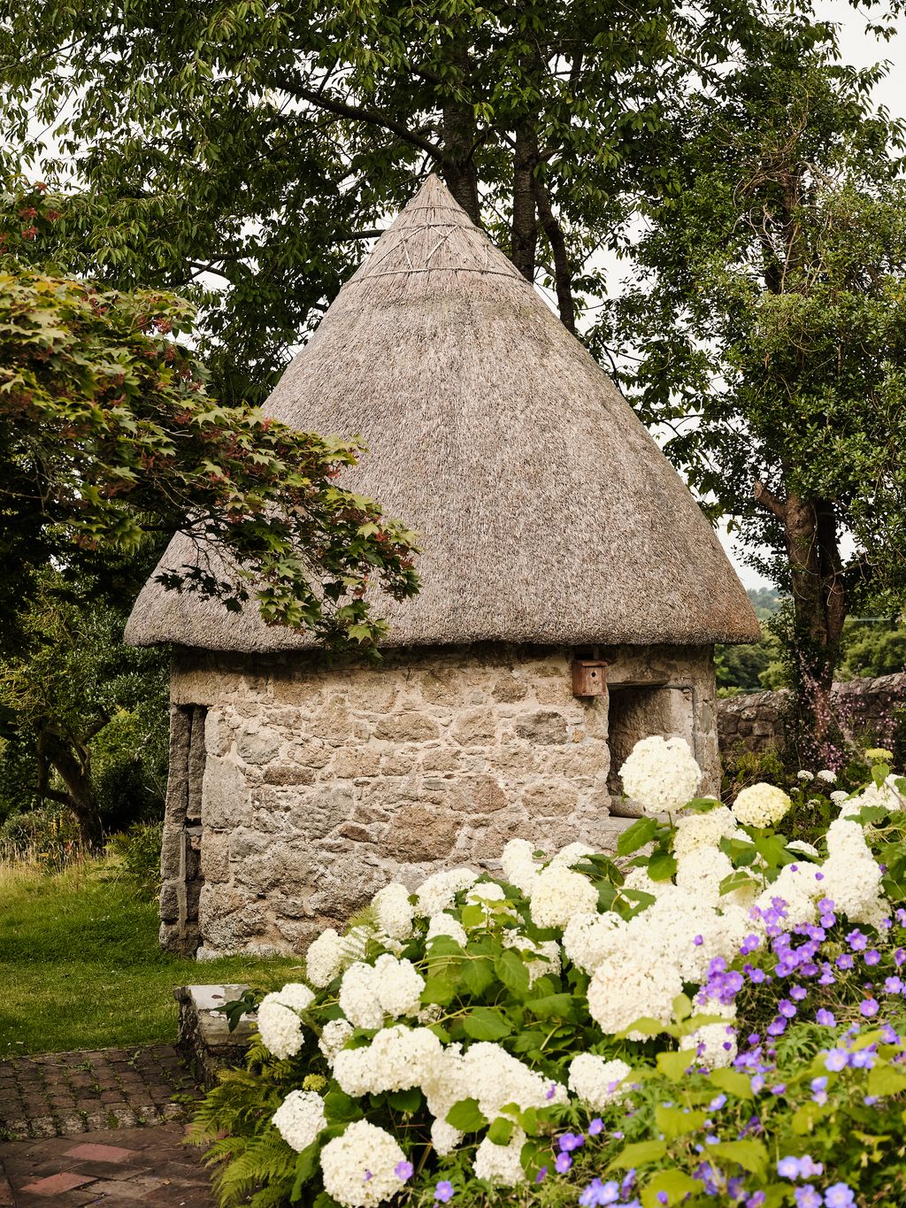 To the left of the house is an ash hut.