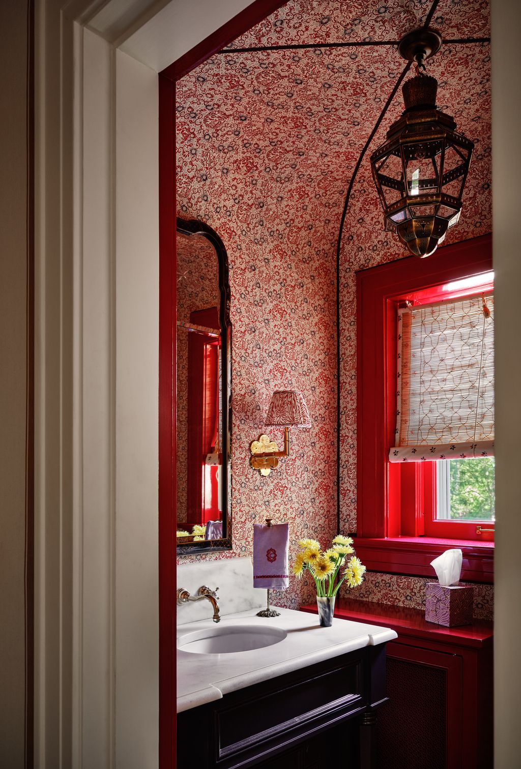 A Le Manach fabric with a Samuel  Sons trim lines the walls in this bathroom. The sconces are Soane and the mirror is an...
