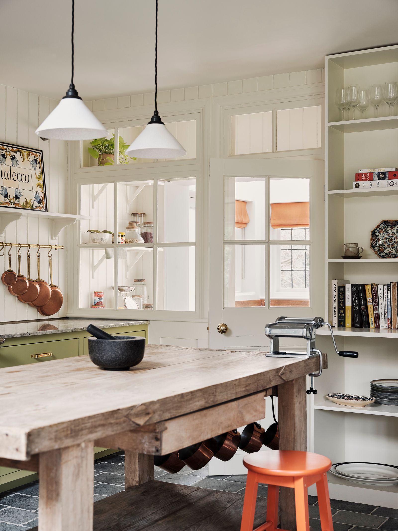 A halfglazed door and an internal window make for a smart partition between kitchen and pantry in this London house by...