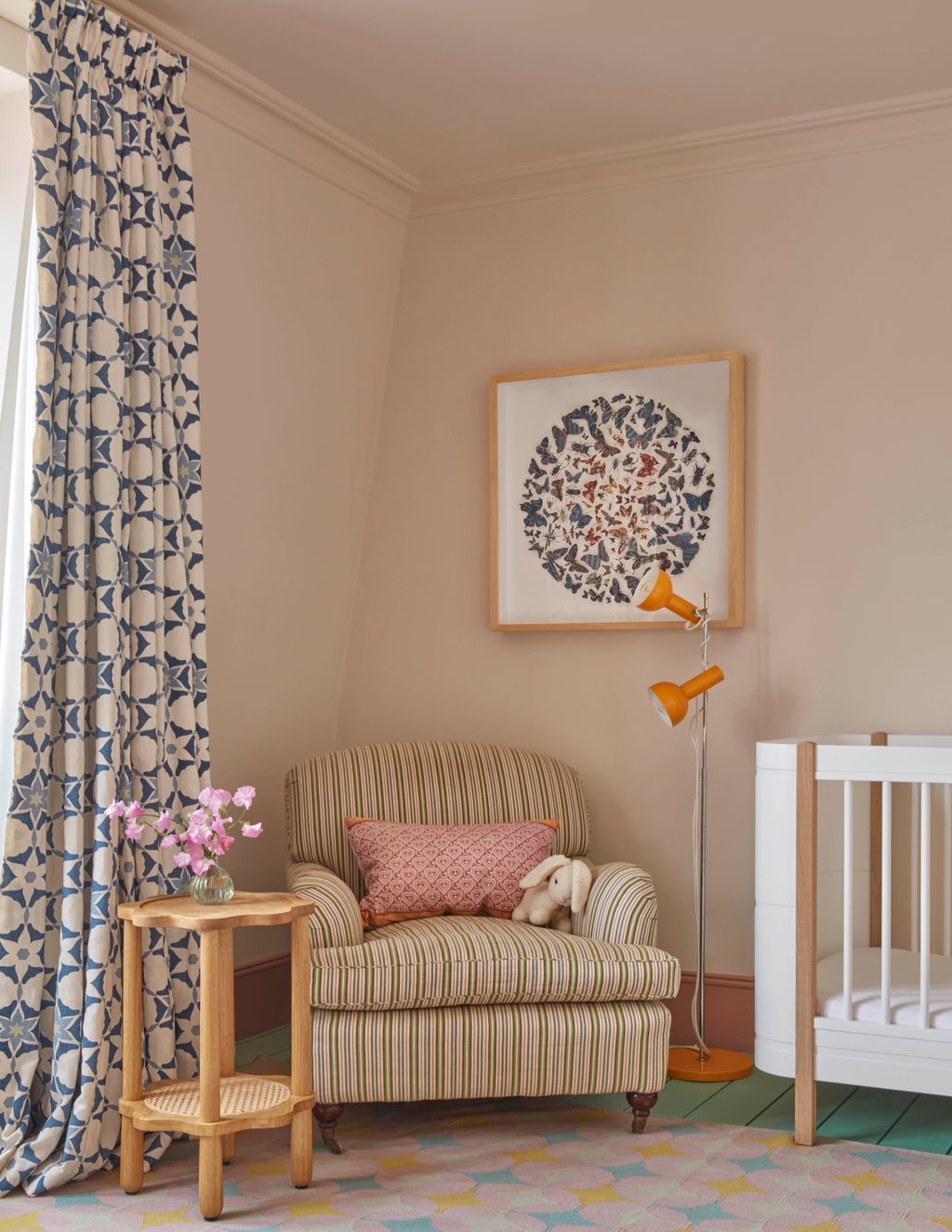 In the babys room a deepseated English armchair by The One Off Chair sits in a corner made cozy by a commissioned...