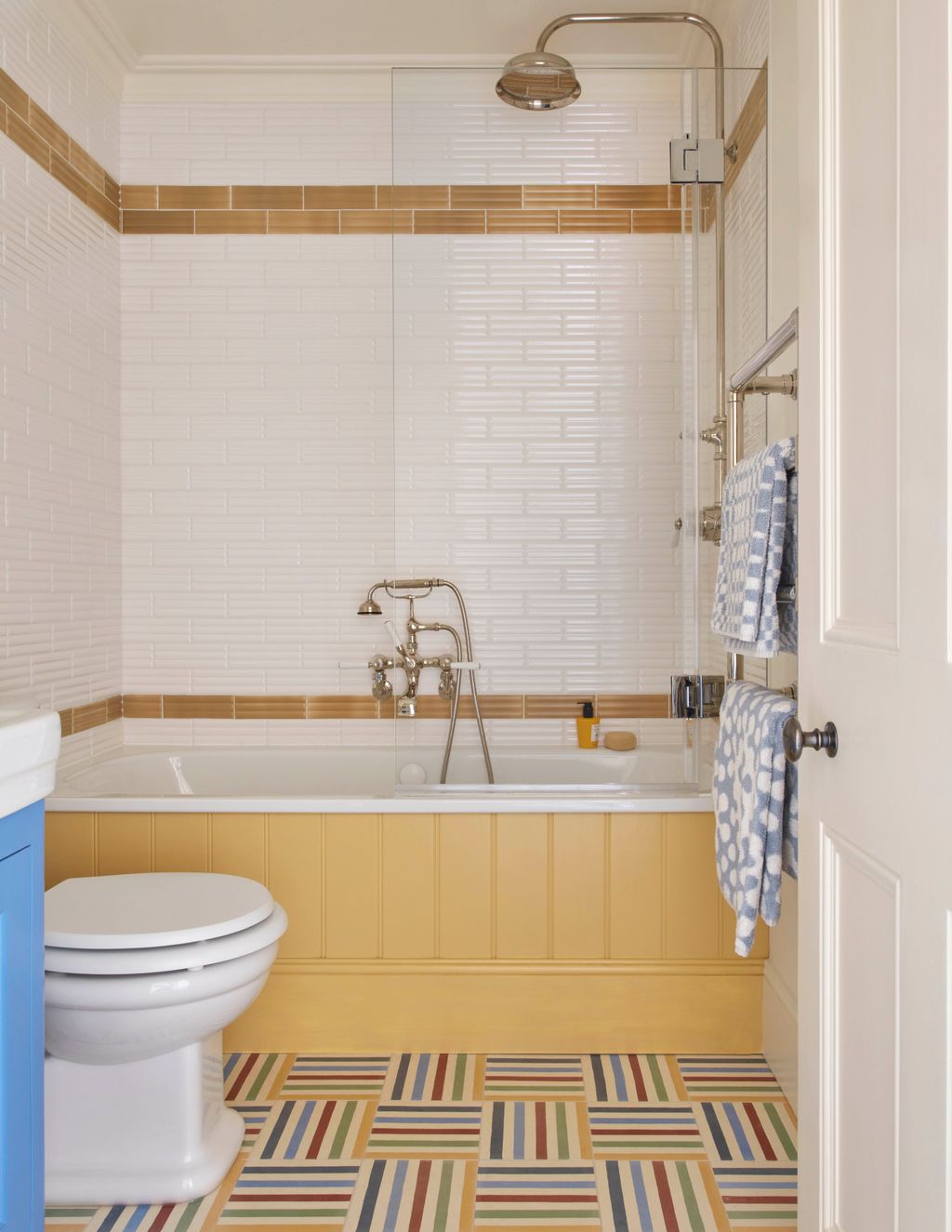 Guinness designed the rainbowstriped tiles in a checkerboard pattern and gave the white walls a boost with bold stripes...