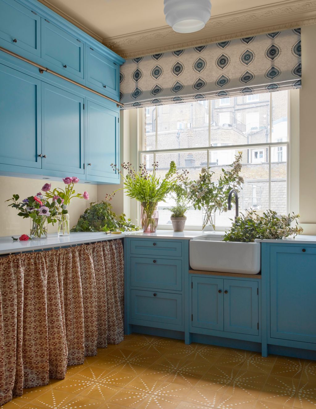 A curtain in Monochrome by Lewis  Wood hides the washer and dryer in the ground floor utility room. Guinness threaded...