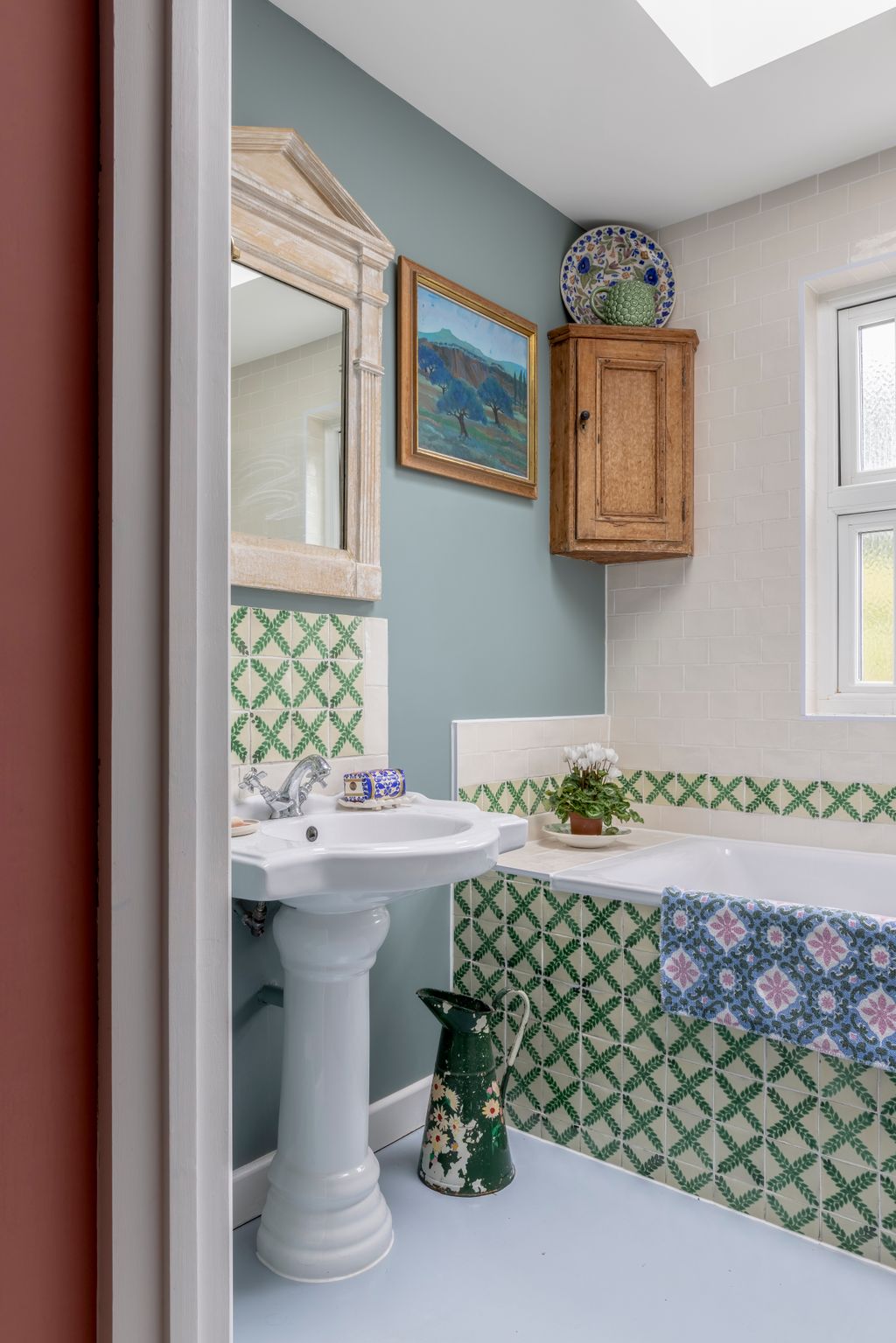The bathroom is painted in Farrow and Ball's ‘Oval Room Blue.