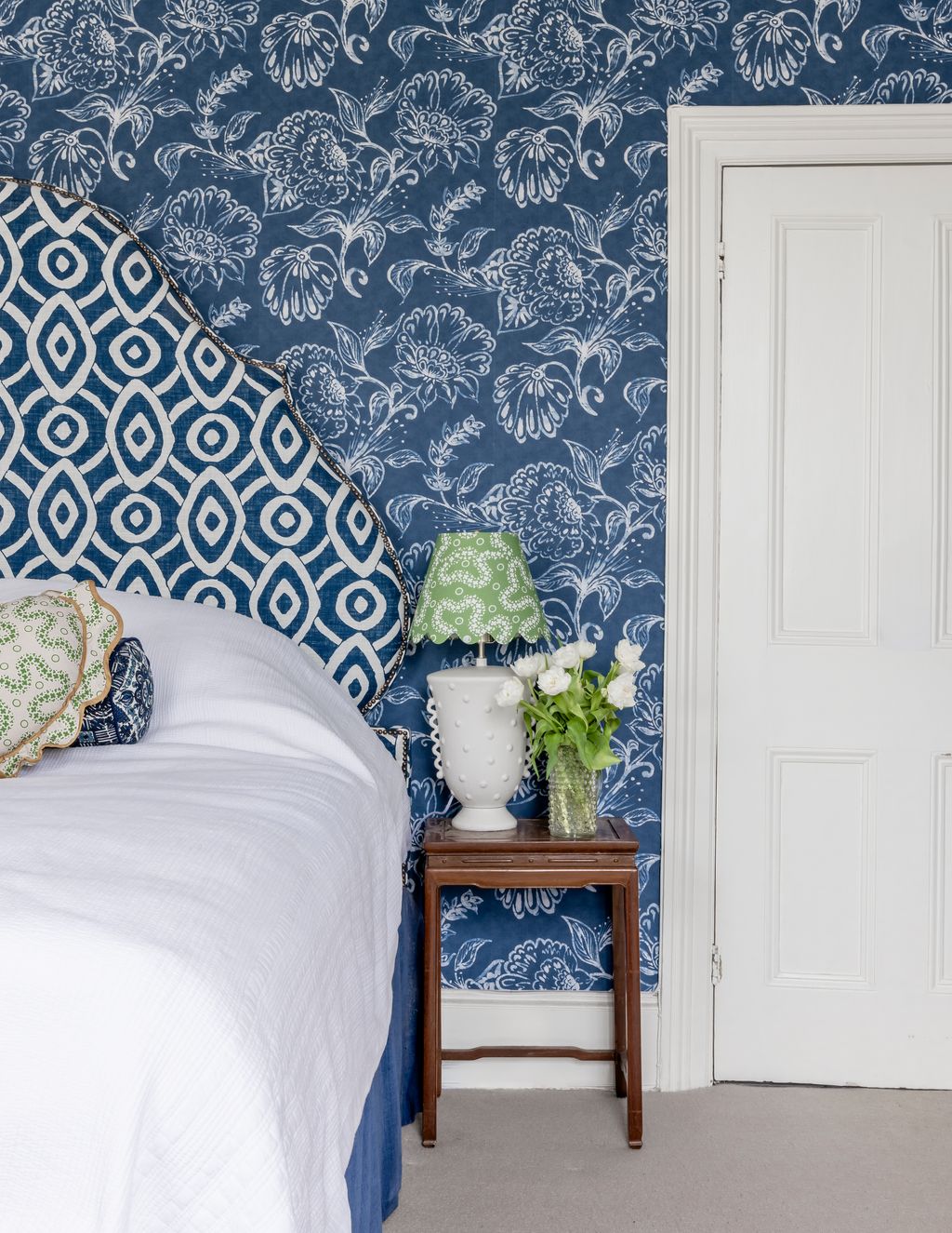 Alice's bedroom is saturated in deep blue. The paper is William Yeoward wallpaper paired with a headboard from the same...