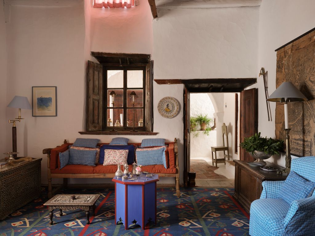 A traditional island sofa with mattress style cushions in a JS fabric. The plate on the wall is 17th century Italian...