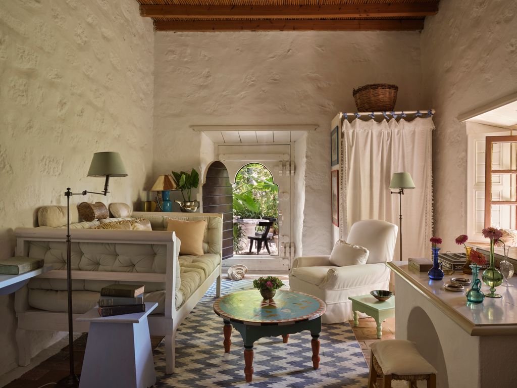 In John's sitting room the low table was painted by a local fishermen. The tables are stone and cement with wooden tops...