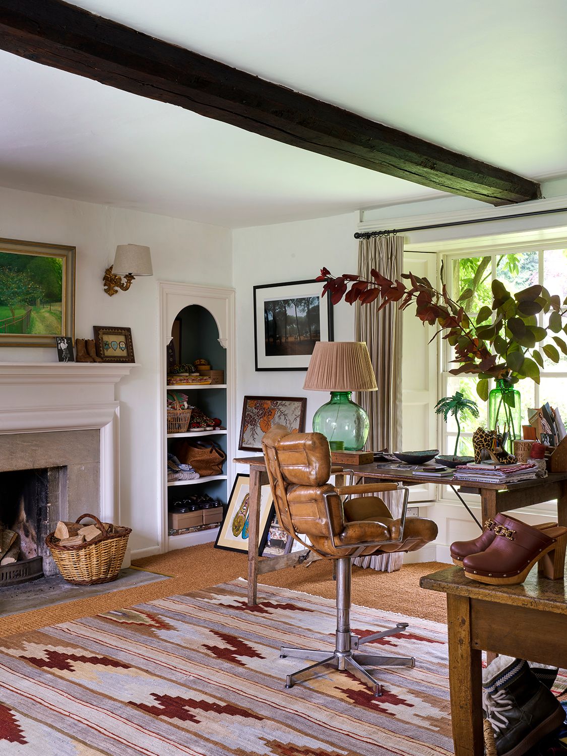 The neutral work space in the study is livened up with a vintage rug picked up in Spain and an antique leather chair....