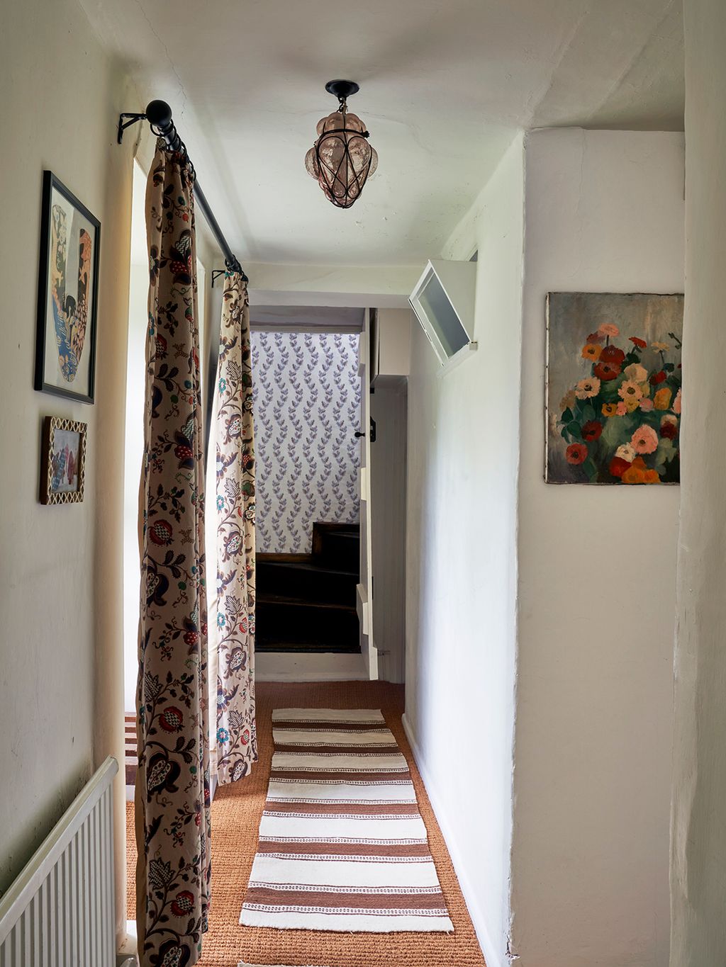 Colour and pattern are brought to the first floor corridor by some curtains from Portobello Road Market which Penelope...