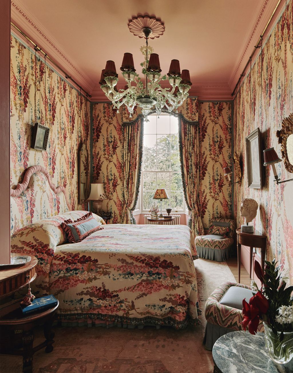 In the main bedroom ‘Lustmore by Jean Monro has been used for the wallcovering curtains headboard and bed complemented...