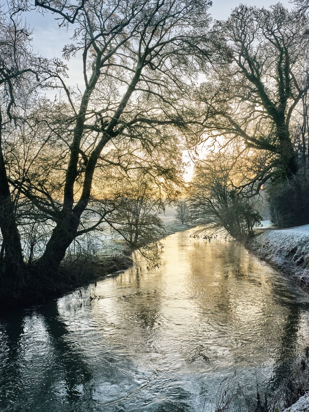 The River Cherwell flows silently along the bottom of the sloping landscape dividing the formal garden from its pastoral...