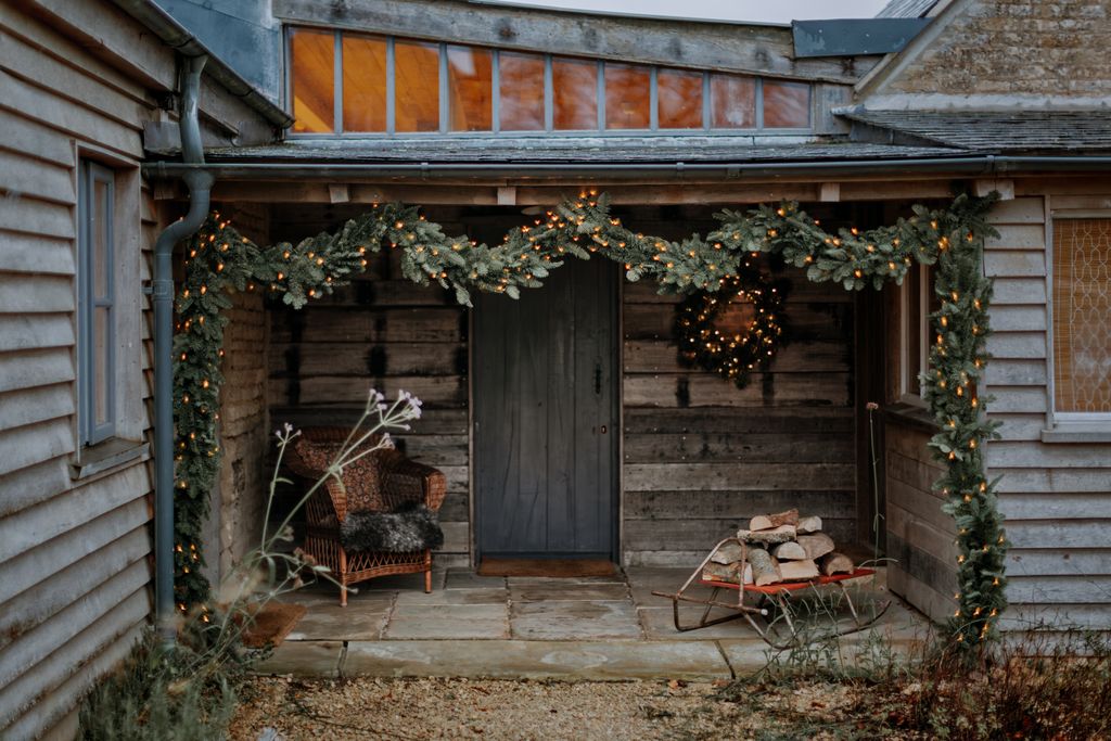 Meanwhile at her guest cottage Amanda Brooks has taken a more minimalist approach festooning the rustic front door with...