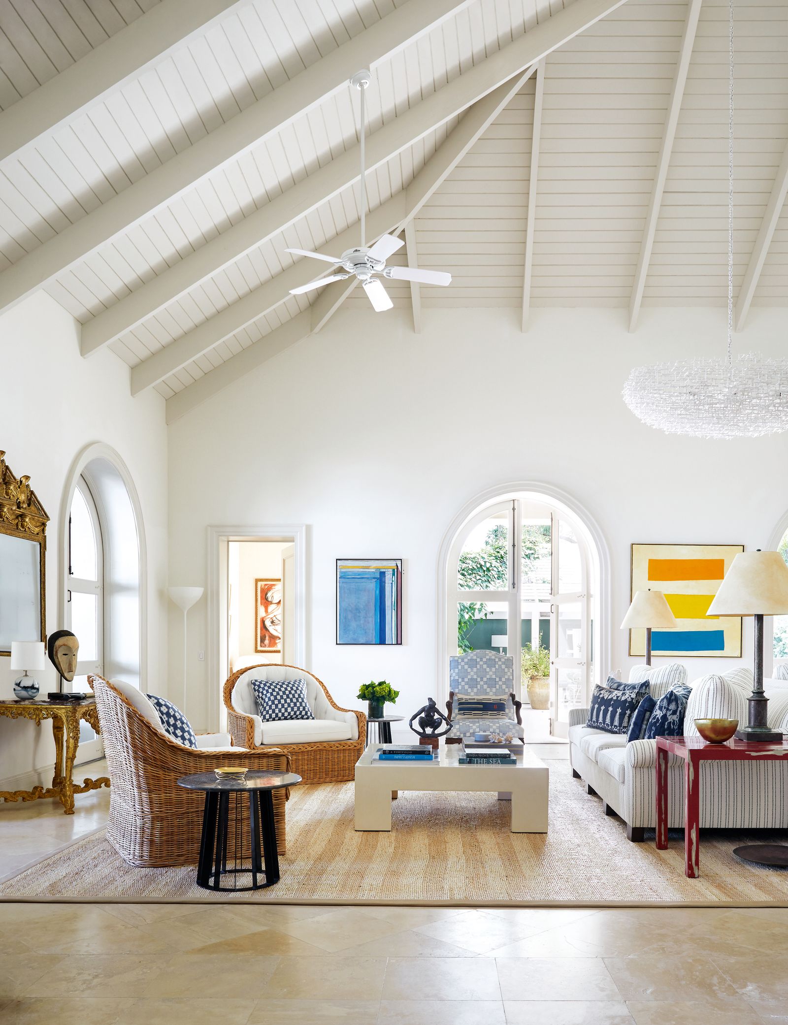 In the sitting room two sofas by Bill Blass  positioned back to back  are teamed with an antique wooden armchair...