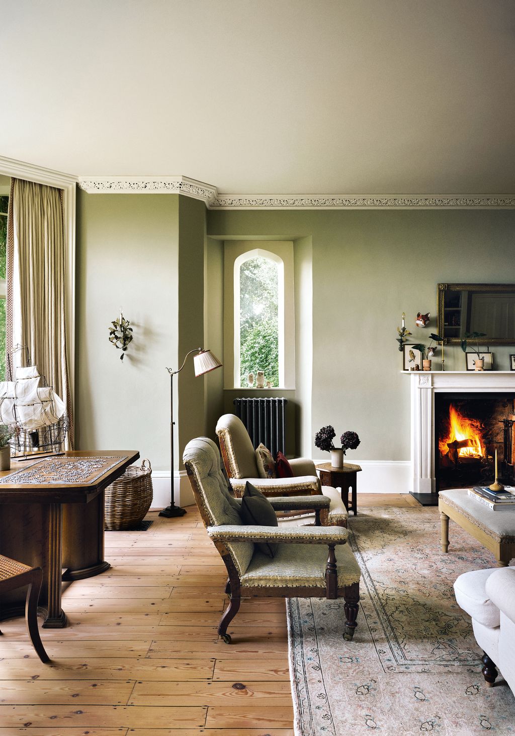 The sitting room of this former vicarage near Bath with characterful layered interiors by Anna Haines is painted in...