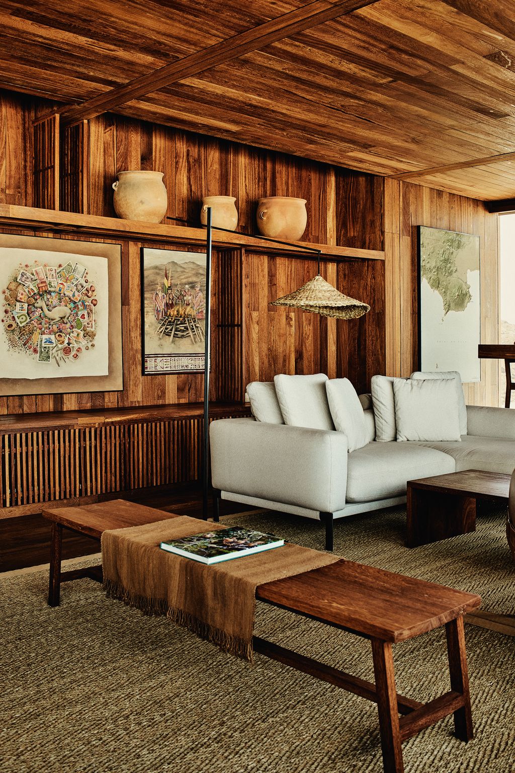 The woodpanelled interior of the Explora lodge at the Uyuni salt flat in Bolivia furnished simply with ceramics artwork...