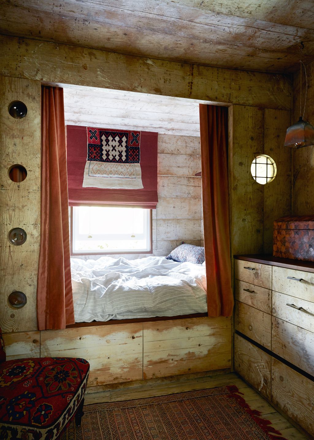 Selecting one material to run throughout a small space can help it to feel more spacious. Reclaimed pine boards once...