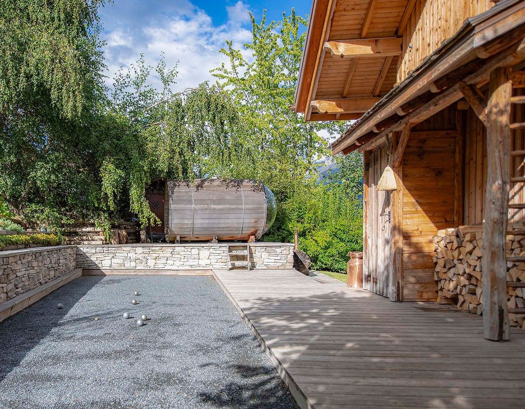 In the garden Chalet les Cerises makes the most of the mountainous view with a traditional sauna complete with glass...