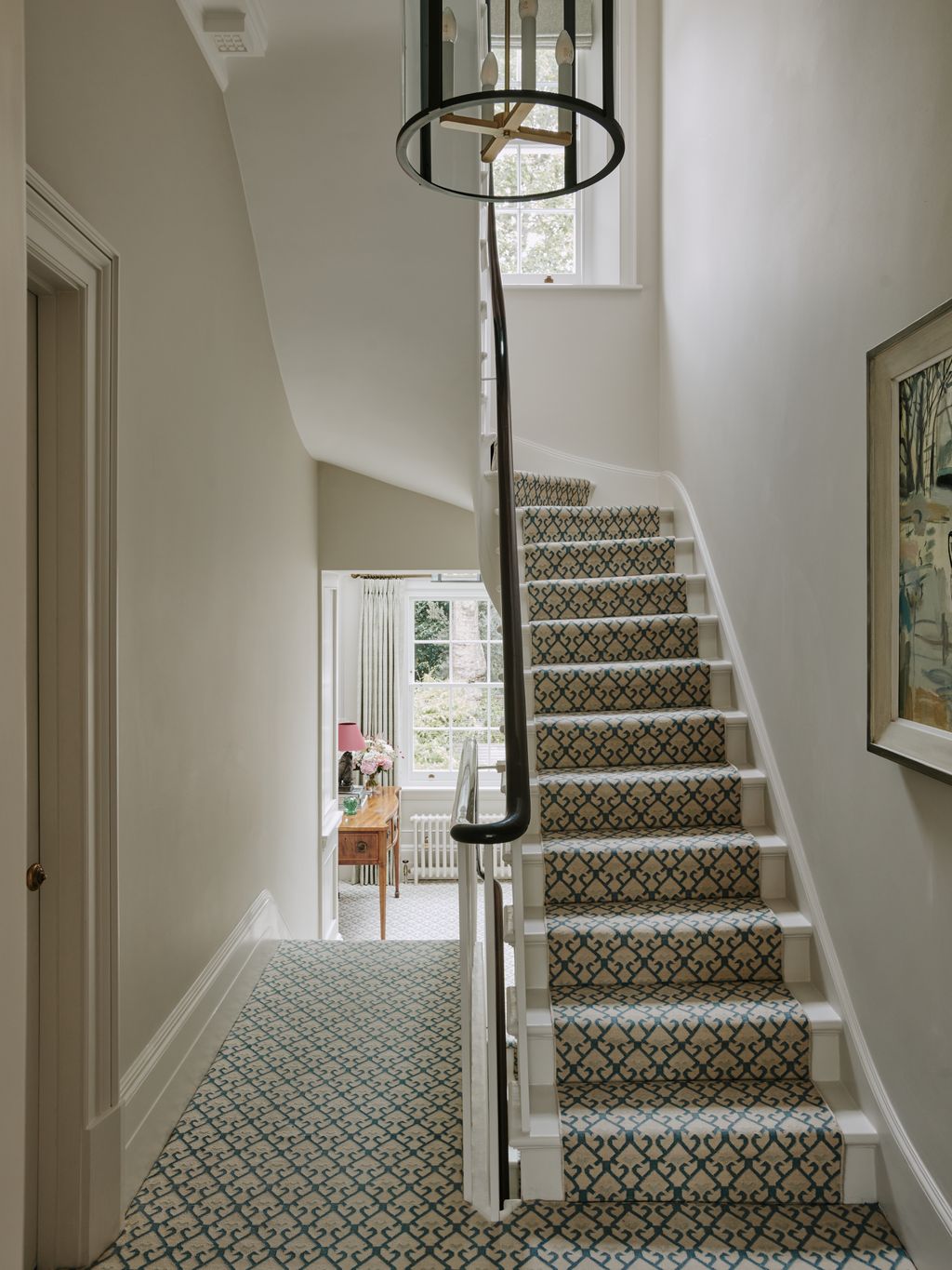 This is an example of a very traditional townhouse landing with narrow proportions whitepainted skirting and a polished...