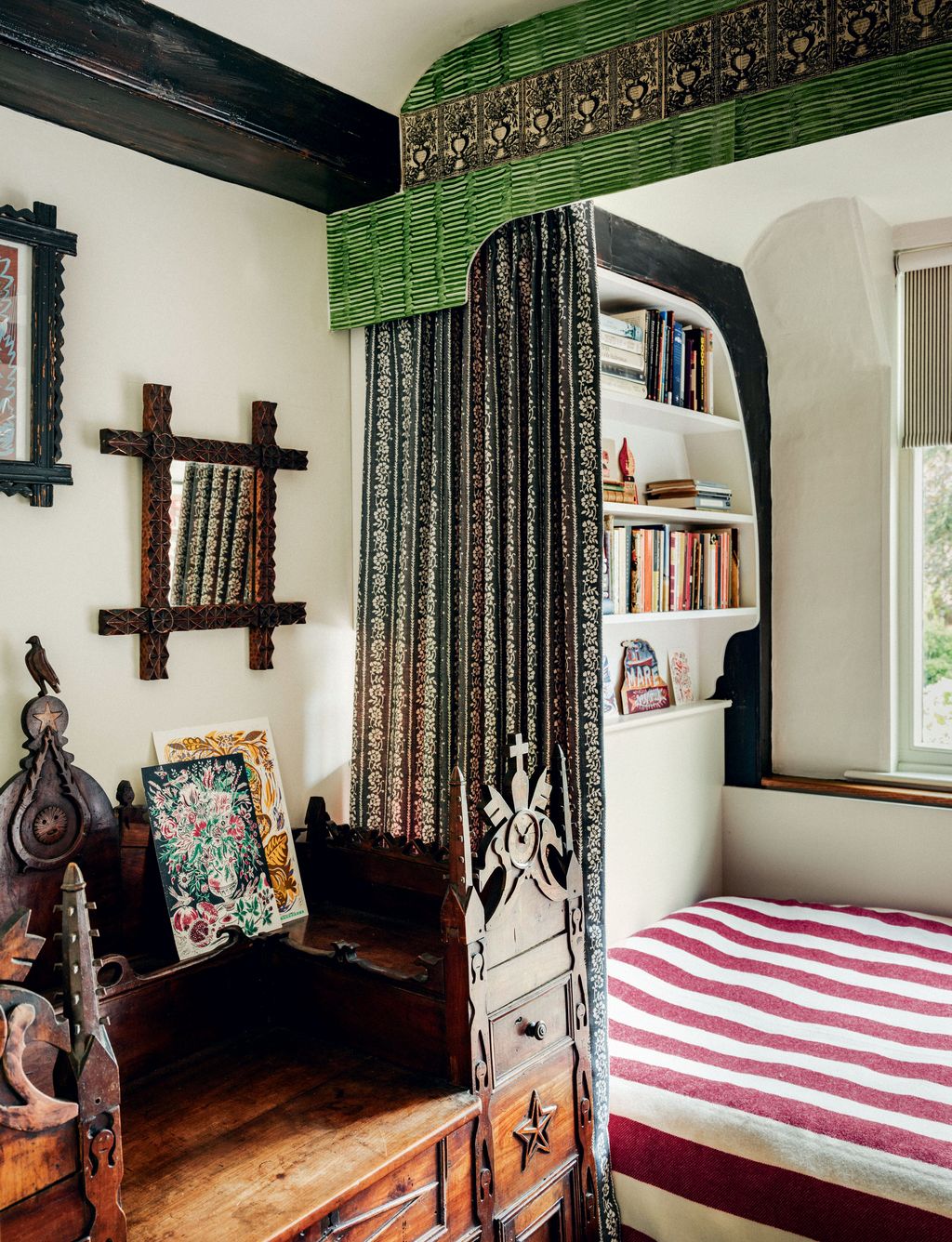 A pelmet decorated with paste paper by Phoebe frames bed curtains in ‘Floral Stripe by Titley and Marr beside a...