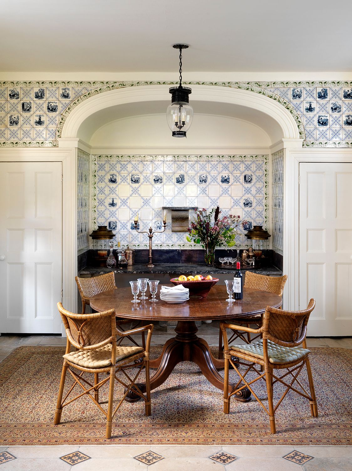 The table here is an antique from Jamb and an antique rug covers the floor.