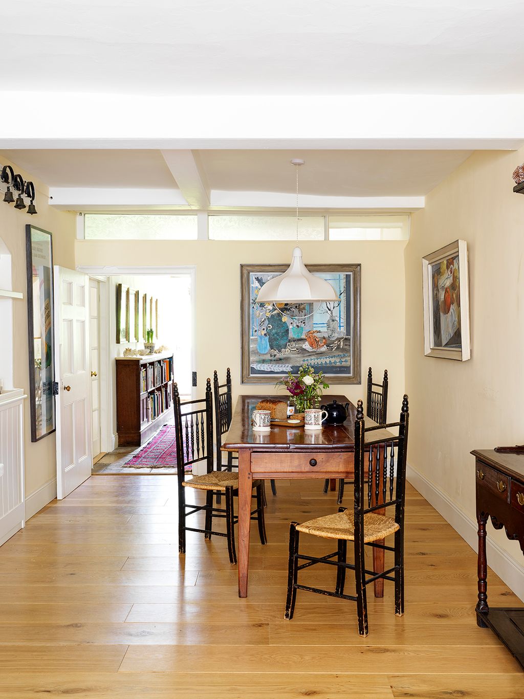 The pendant light in the dining area is by Beata Heuman.