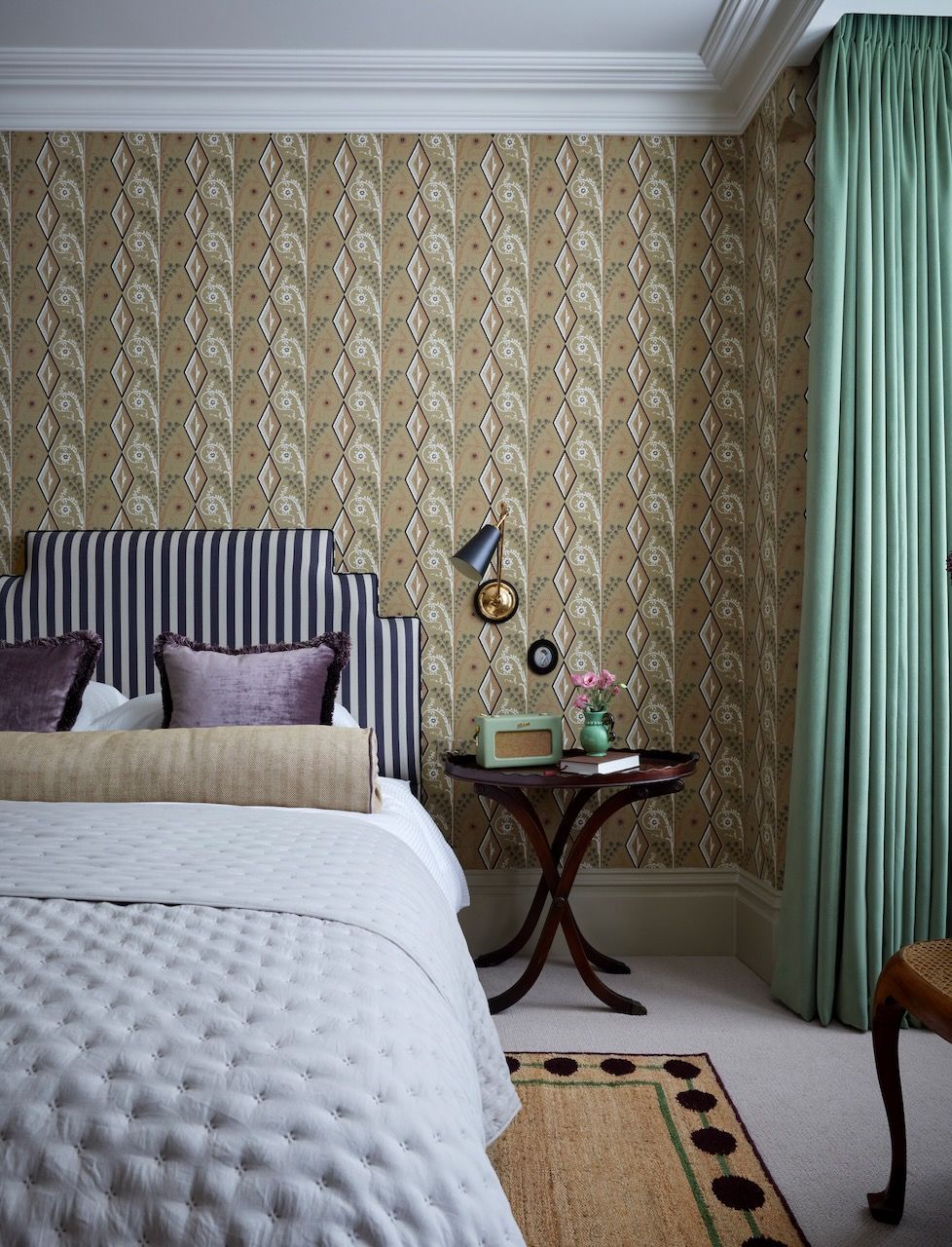 In this Victorian London flat Laura Stephens has chosen a bolster that picks up on the colour of the wallpaper.
