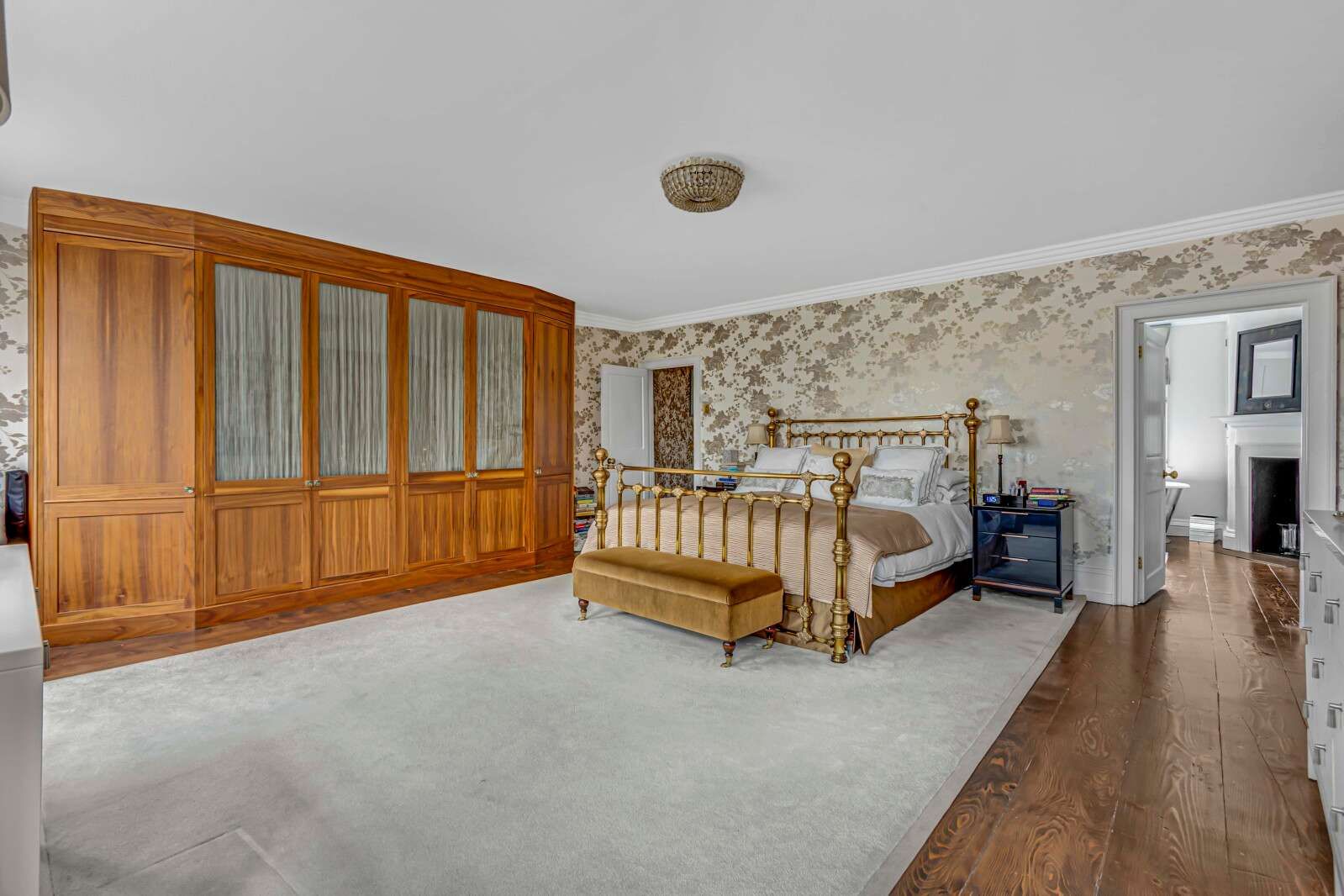 Image may contain Indoors Interior Design Bed Furniture Wood Lamp Hardwood Home Decor Rug Bedroom and Room
