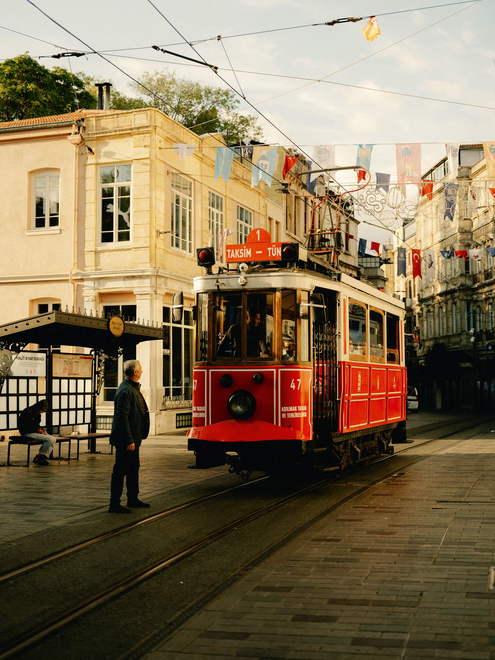 Image may contain Cable Car Transportation Vehicle Person Clothing Footwear Shoe Streetcar Car and Light