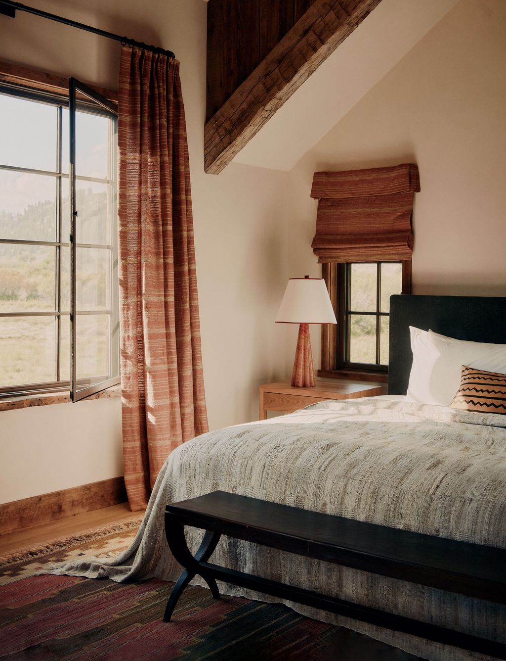 Image may contain Lamp Indoors Interior Design Home Decor Bed Furniture Bench Window and Table Lamp