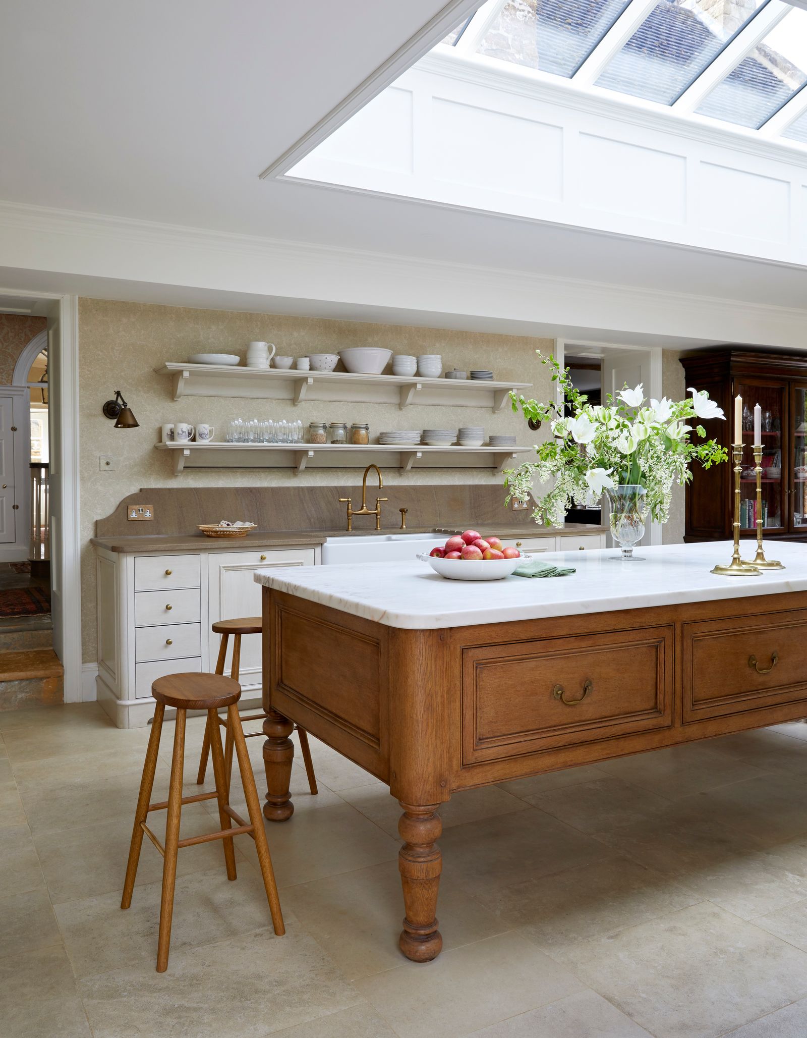 Image may contain Indoors Interior Design Kitchen Kitchen Island Sink Sink Faucet Cup Lamp Candle and Furniture