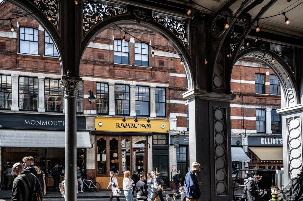 Image may contain City Terminal Urban Person Adult Clothing Hat Bicycle Transportation Vehicle and Accessories