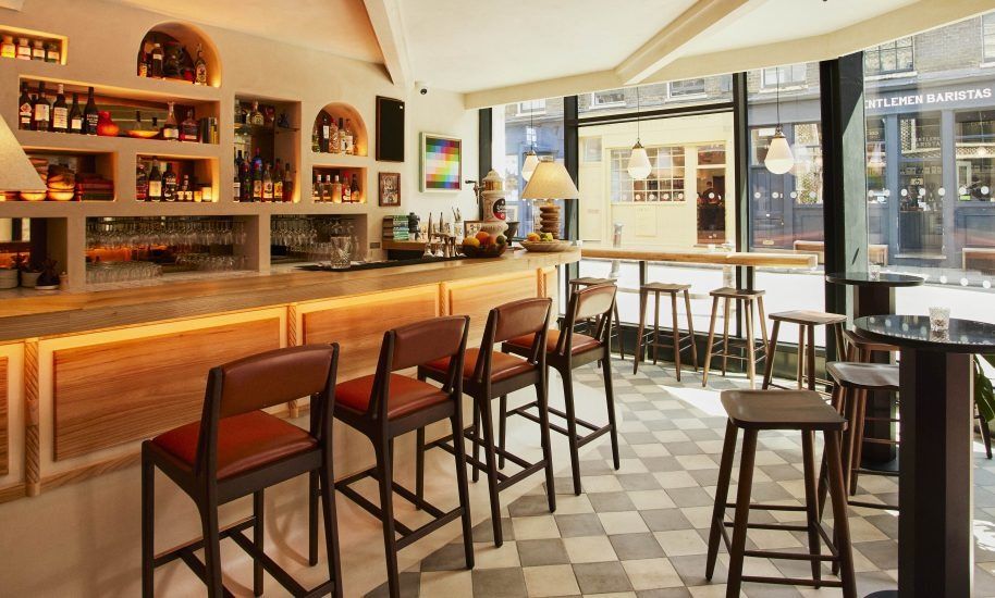 Image may contain Chair Furniture Lamp Cup Art Painting Bar Desk Table and Person