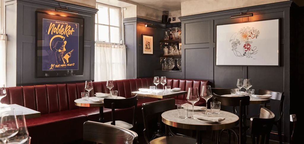 Image may contain Indoors Restaurant Architecture Building Dining Room Dining Table Furniture Room Table and Cup