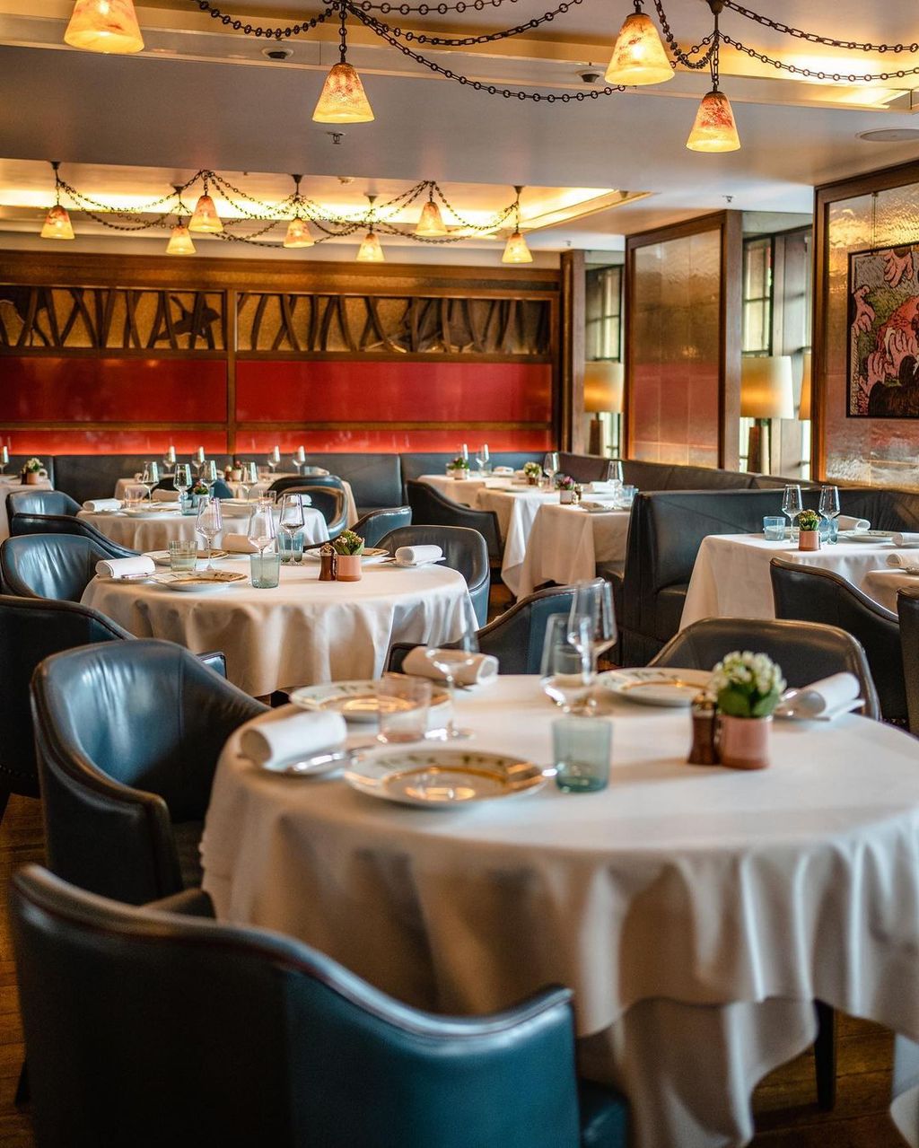 Image may contain Indoors Cup Lamp Chair Furniture Plate Hall Fun Dining Table Table Banquet and Person