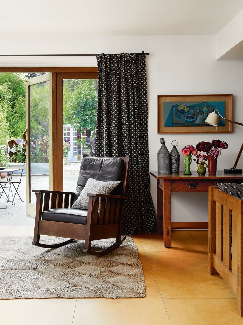 Image may contain Home Decor Rug Chair Furniture Desk Table Art Painting Indoors Interior Design Person and Floor