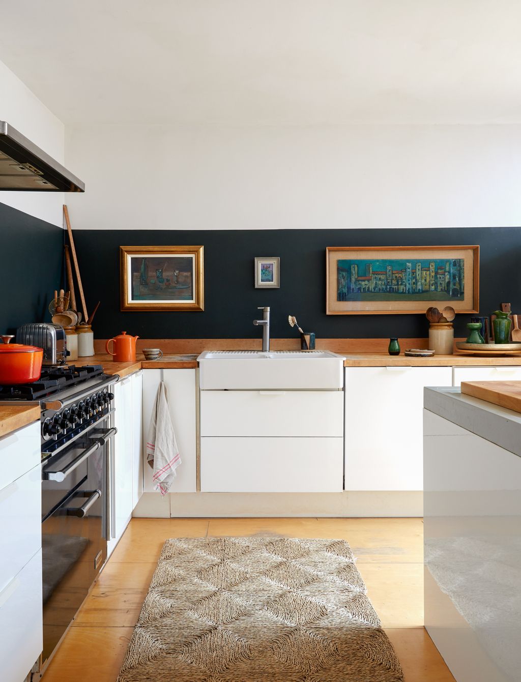 Image may contain Home Decor Indoors Interior Design Kitchen Rug Art Painting Sink Sink Faucet Cooktop and Cup