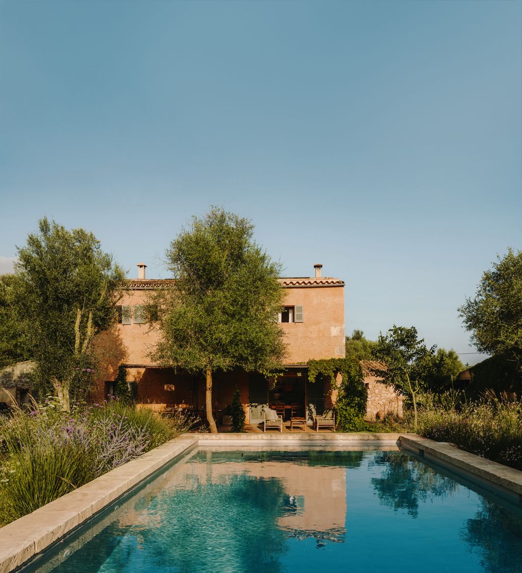 Image may contain Architecture Building House Housing Villa Pool Water Swimming Pool Chair Furniture and Outdoors