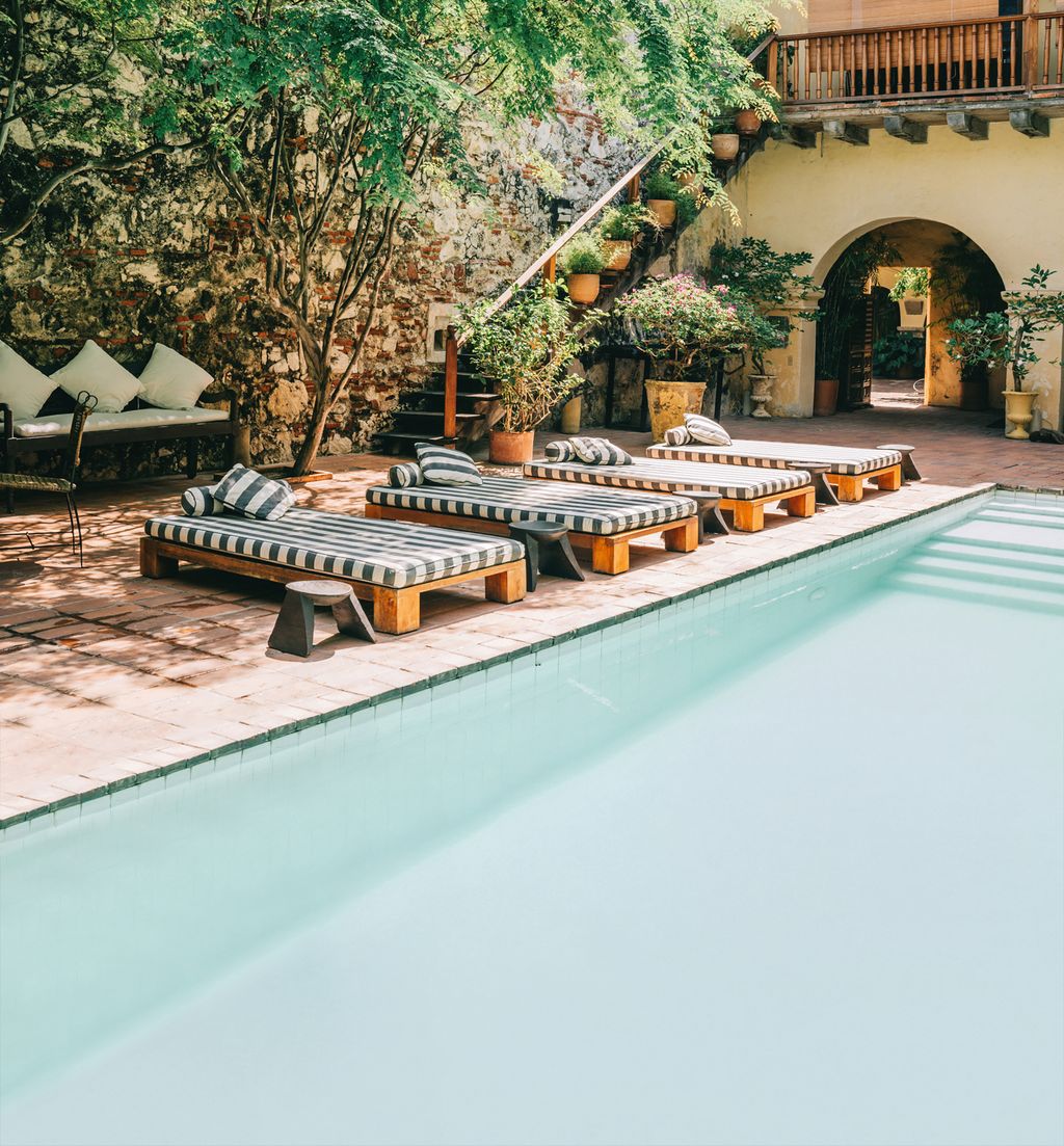 Image may contain Architecture Building Hotel Resort House Housing Villa Plant Pool Water Chair and Furniture