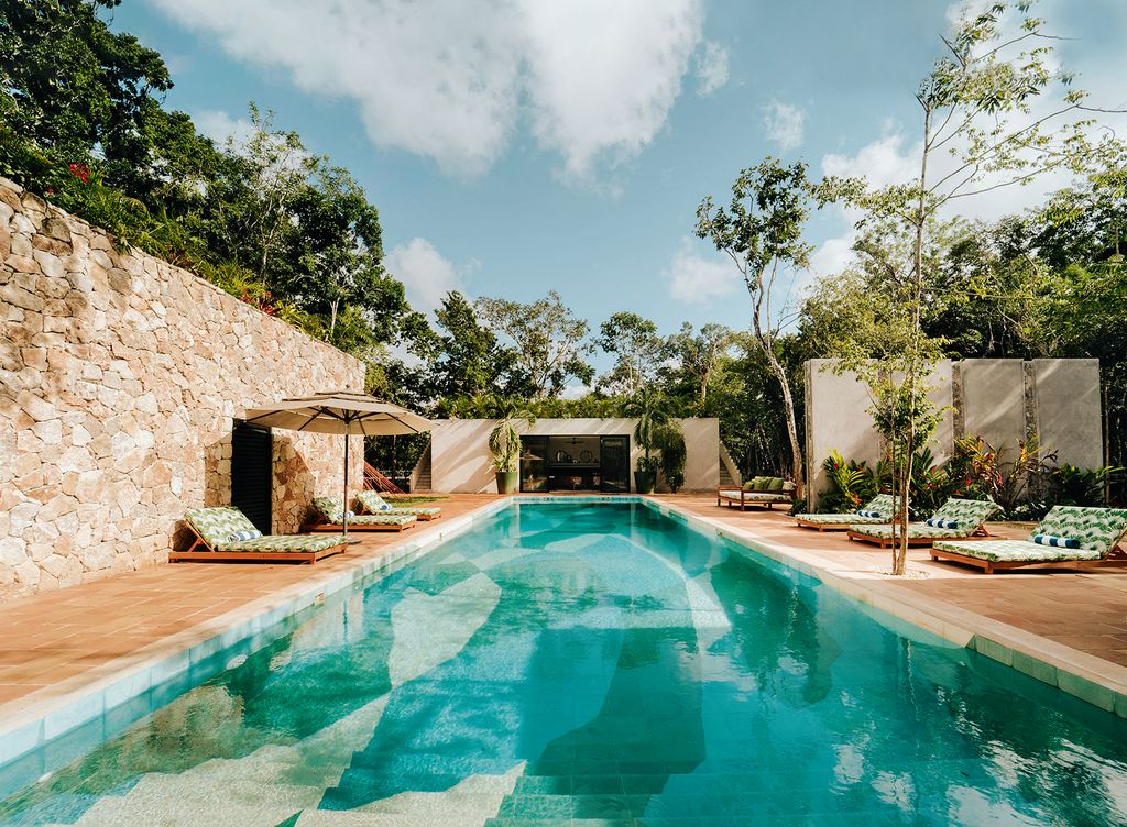 Image may contain Architecture Building House Housing Villa Pool Water Swimming Pool Plant Hotel and Resort