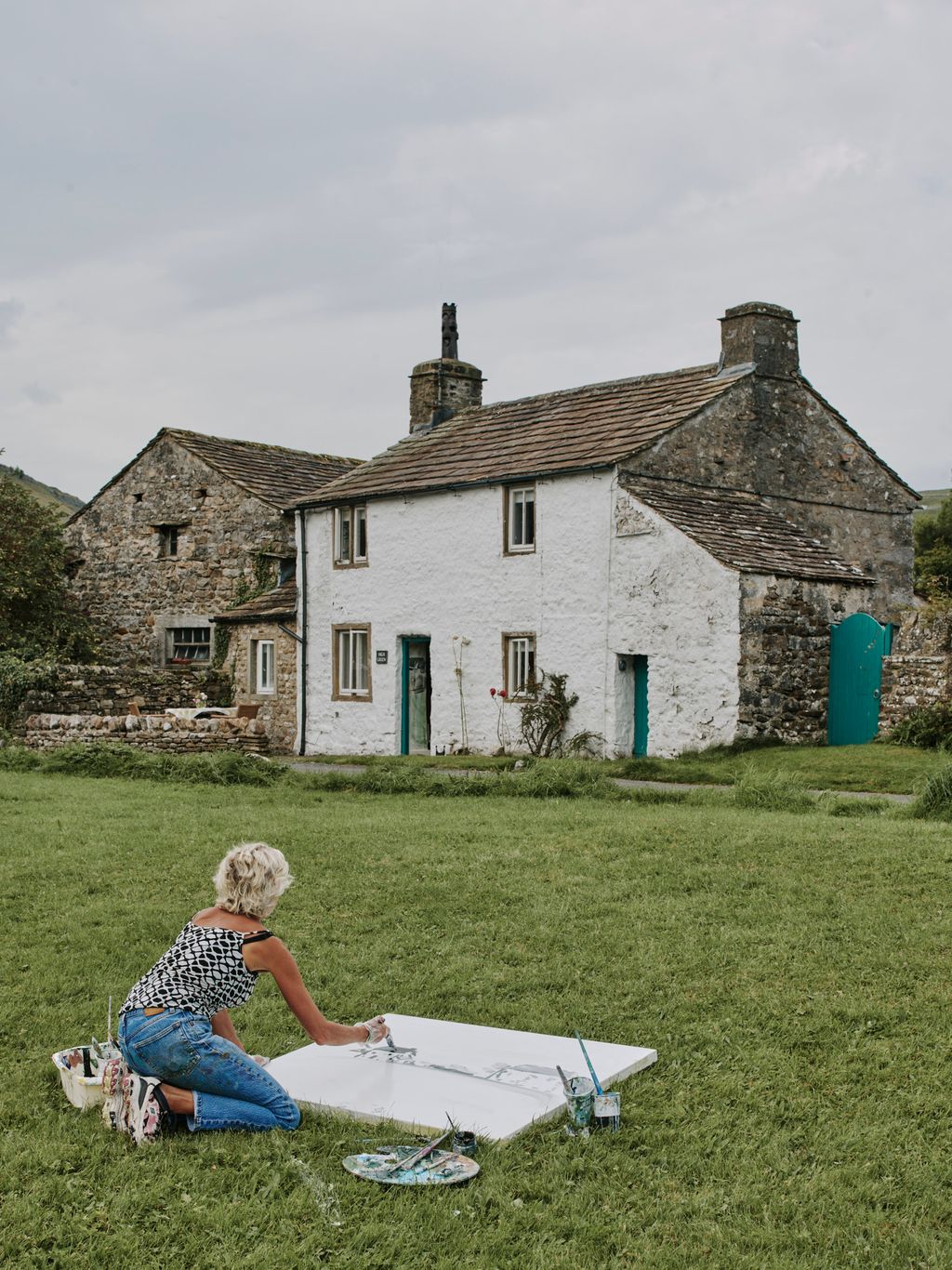 Image may contain Grass Plant Architecture Building Cottage House Housing Outdoors Shelter Adult Person and Lawn