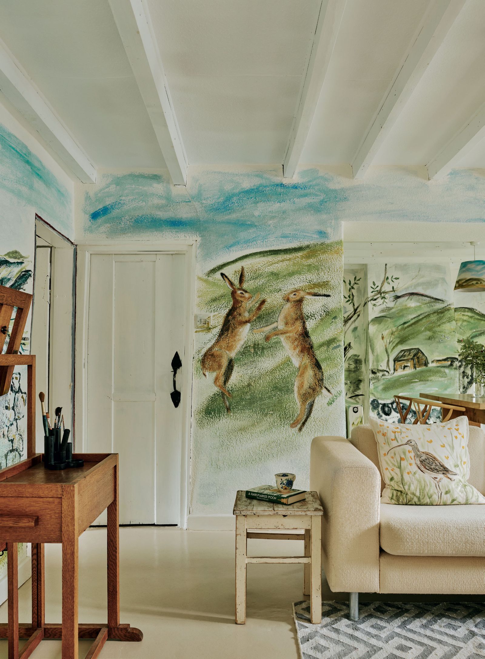 Image may contain Art Painting Architecture Building Furniture Indoors Living Room Room Book Publication and Cup