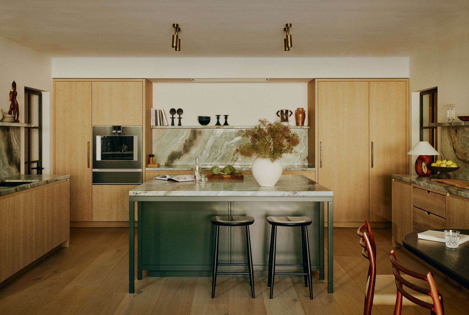 Image may contain Indoors Interior Design Book Publication Kitchen Lamp Cup Chair Furniture and Plant