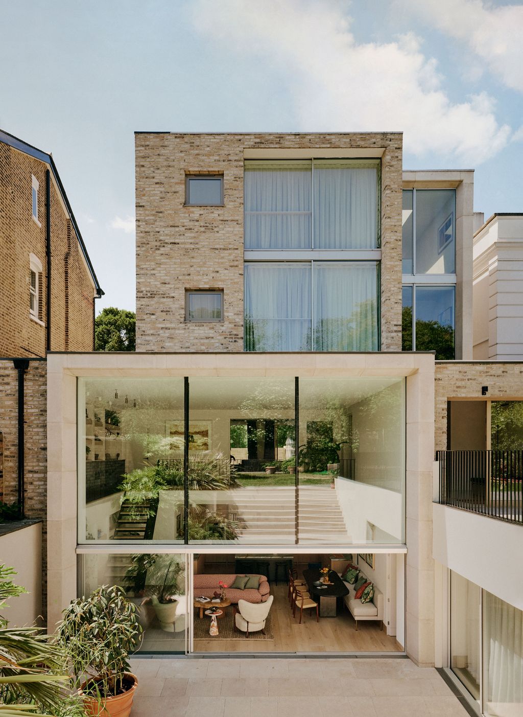 Image may contain Architecture Balcony Building City Plant Chair Furniture Indoors Interior Design Urban and Couch