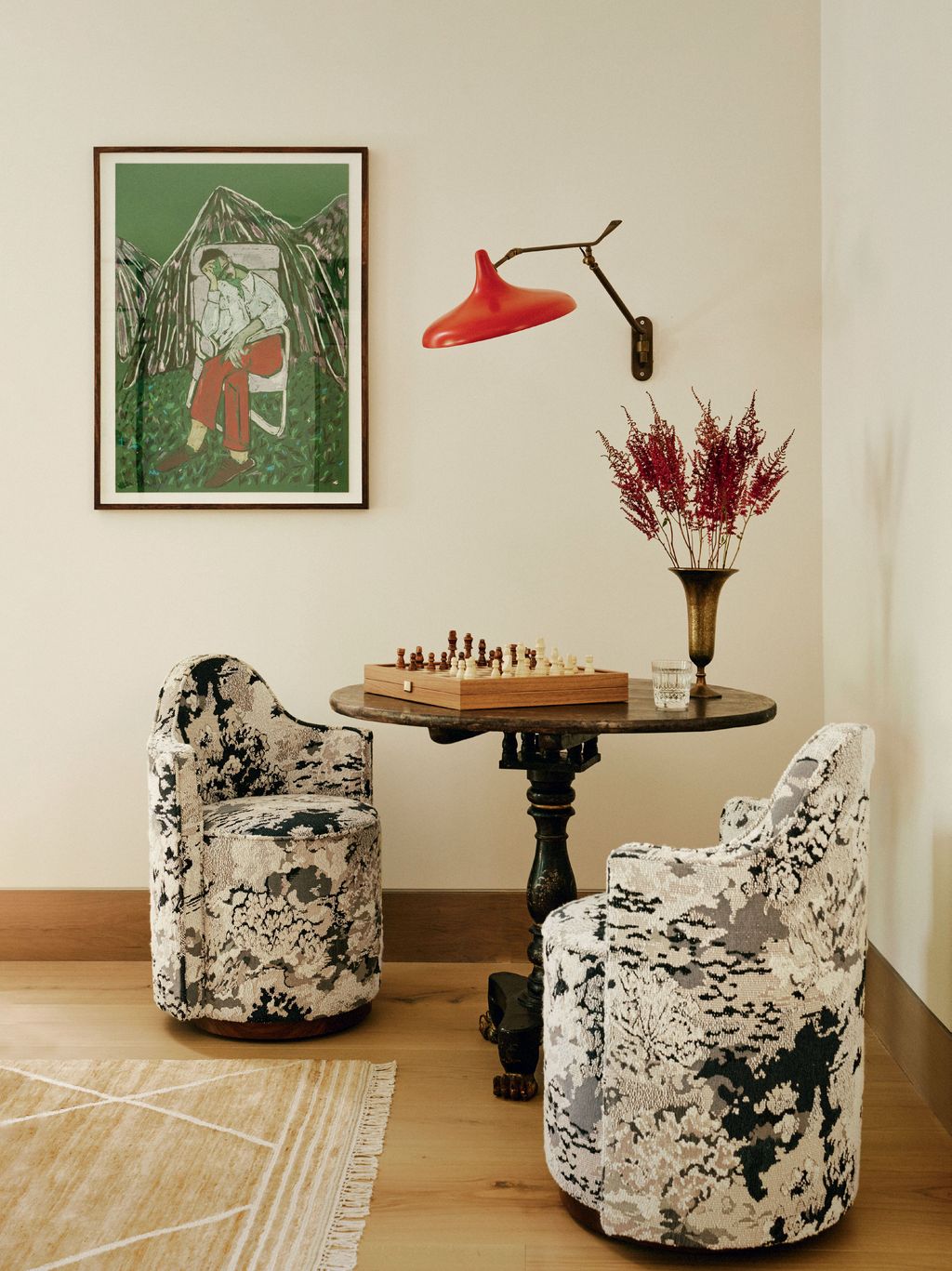 Image may contain Furniture Desk Table Home Decor Rug Cup Art Painting Chair Person Chess and Game