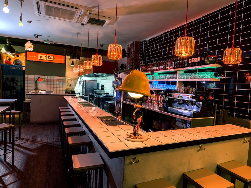 Image may contain Lamp Bar and Person