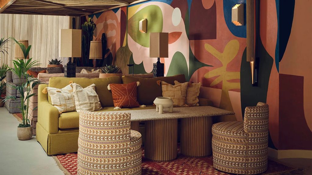 Image may contain Home Decor Architecture Building Furniture Indoors Living Room Room Lamp Plant and Couch